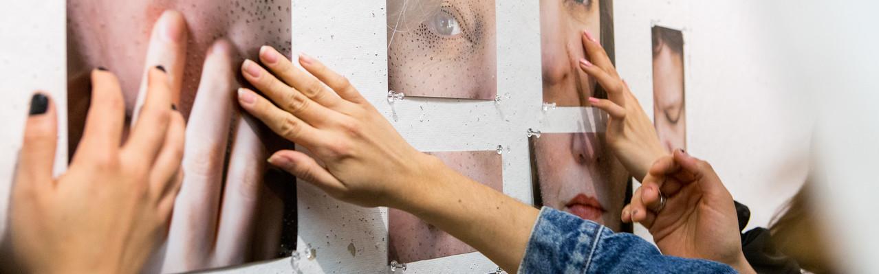 many hands touching photographs
