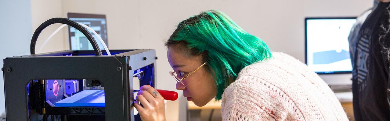 student working on a 3D printer