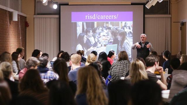 Kevin giving presentation at a career workshop to a room of people