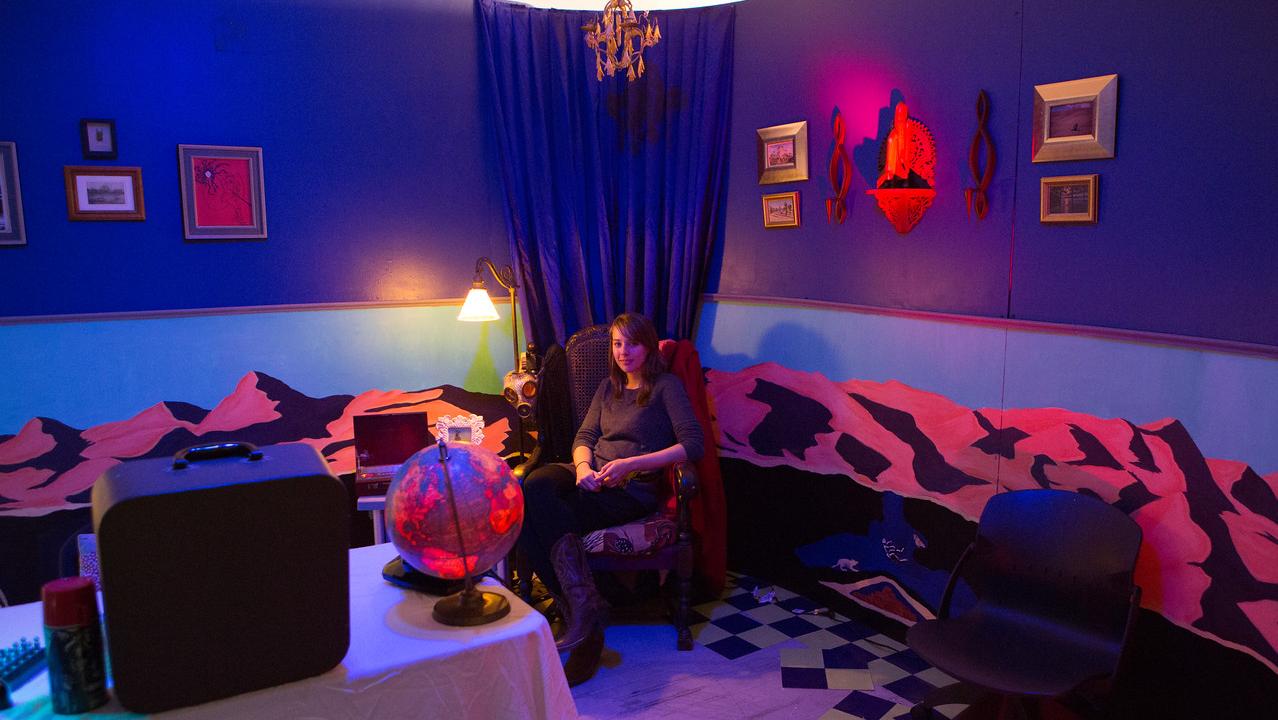 artist sitting in emersive installation piece