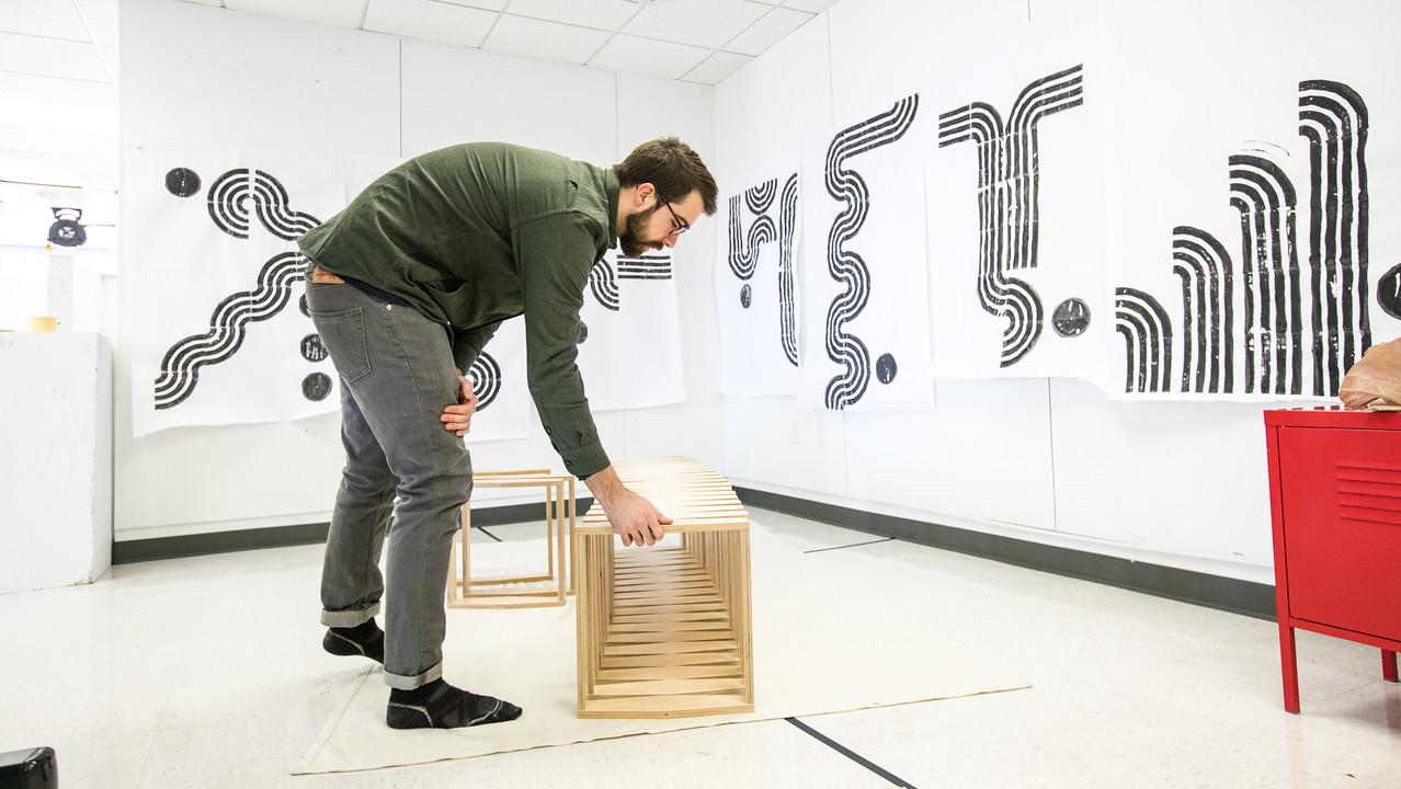 artist working on furniture piece