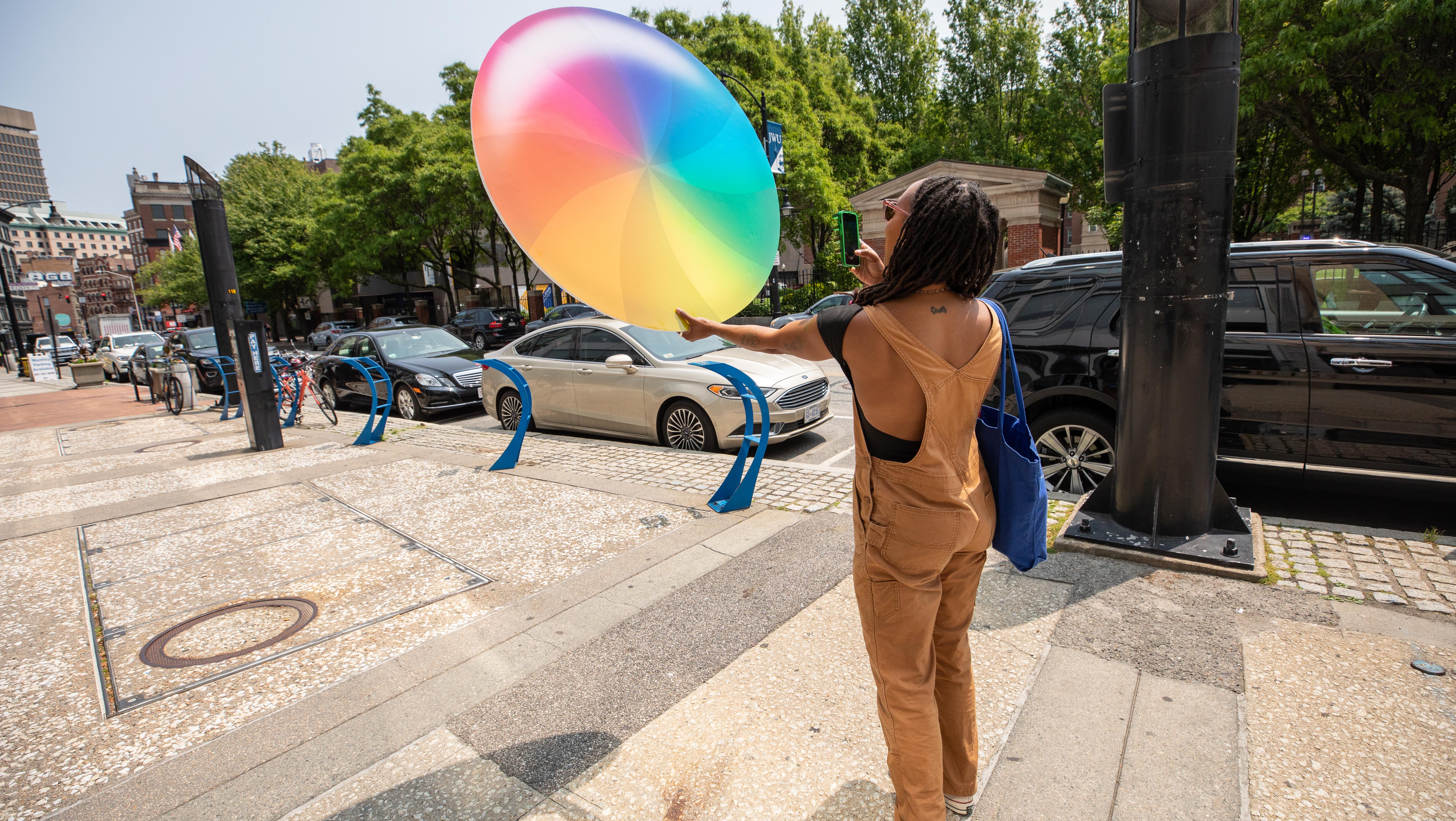 artist displaying work on public street