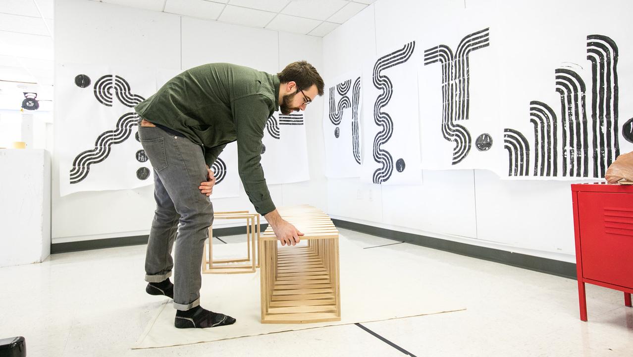 artist setting up furniture piece