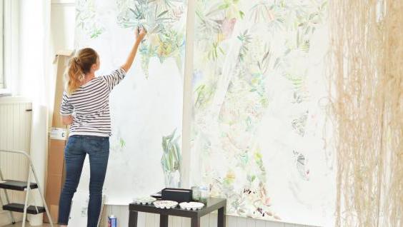 artist painting on large canvas