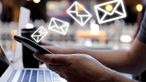 person sending emails from their phone