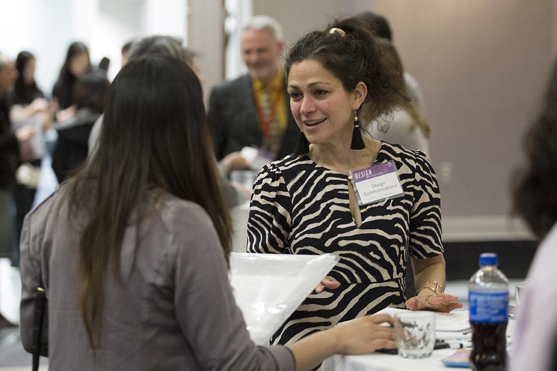 Employer networks with students at the Design Portfolio Review, Networking Reception.