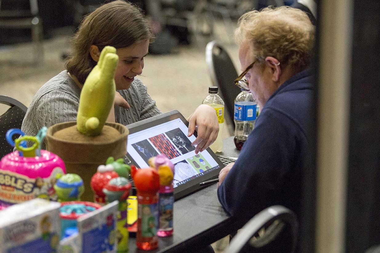 A student shows portfolio at the Design Portfolio Review.
