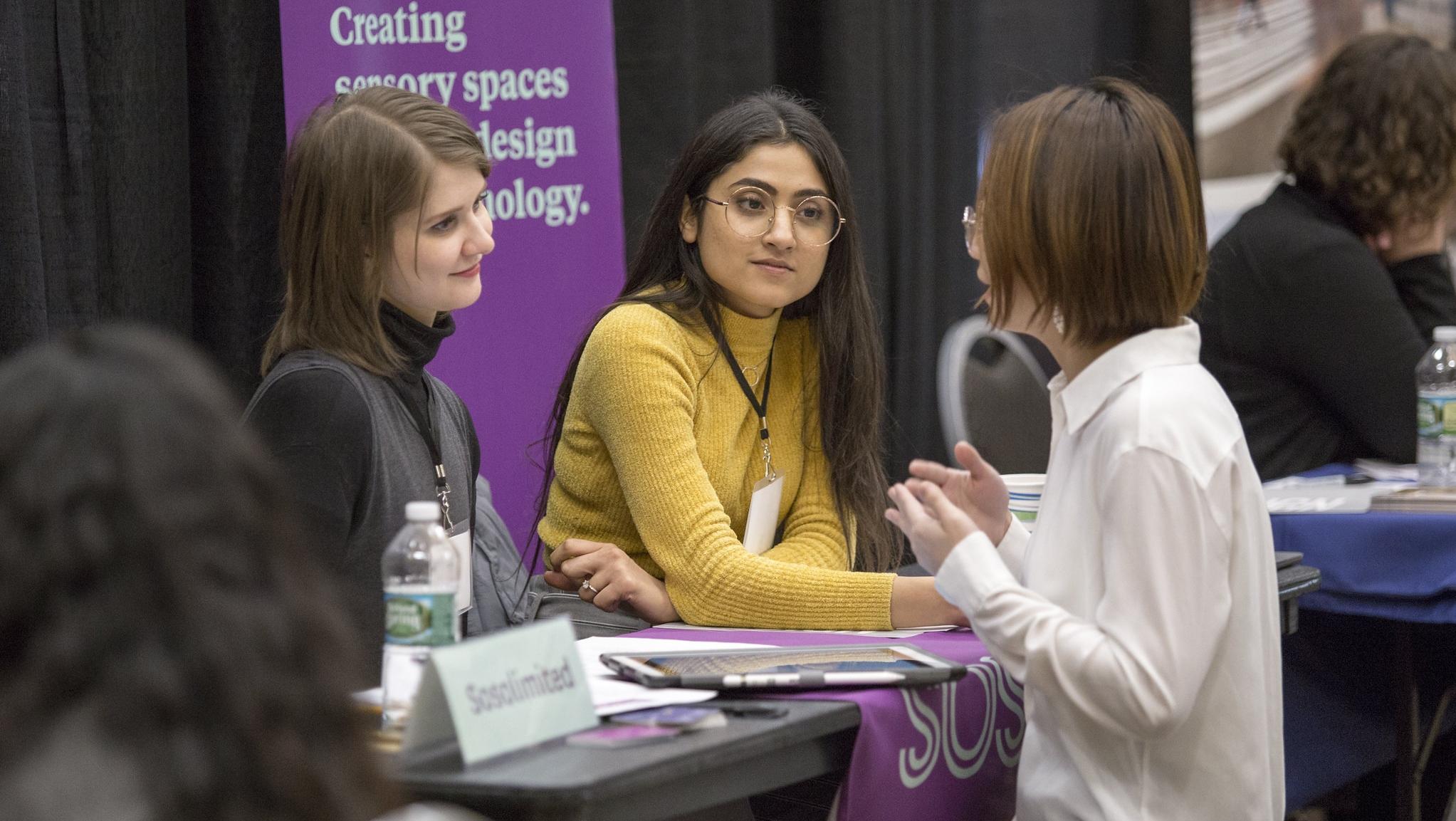 student showing portfolio to employer