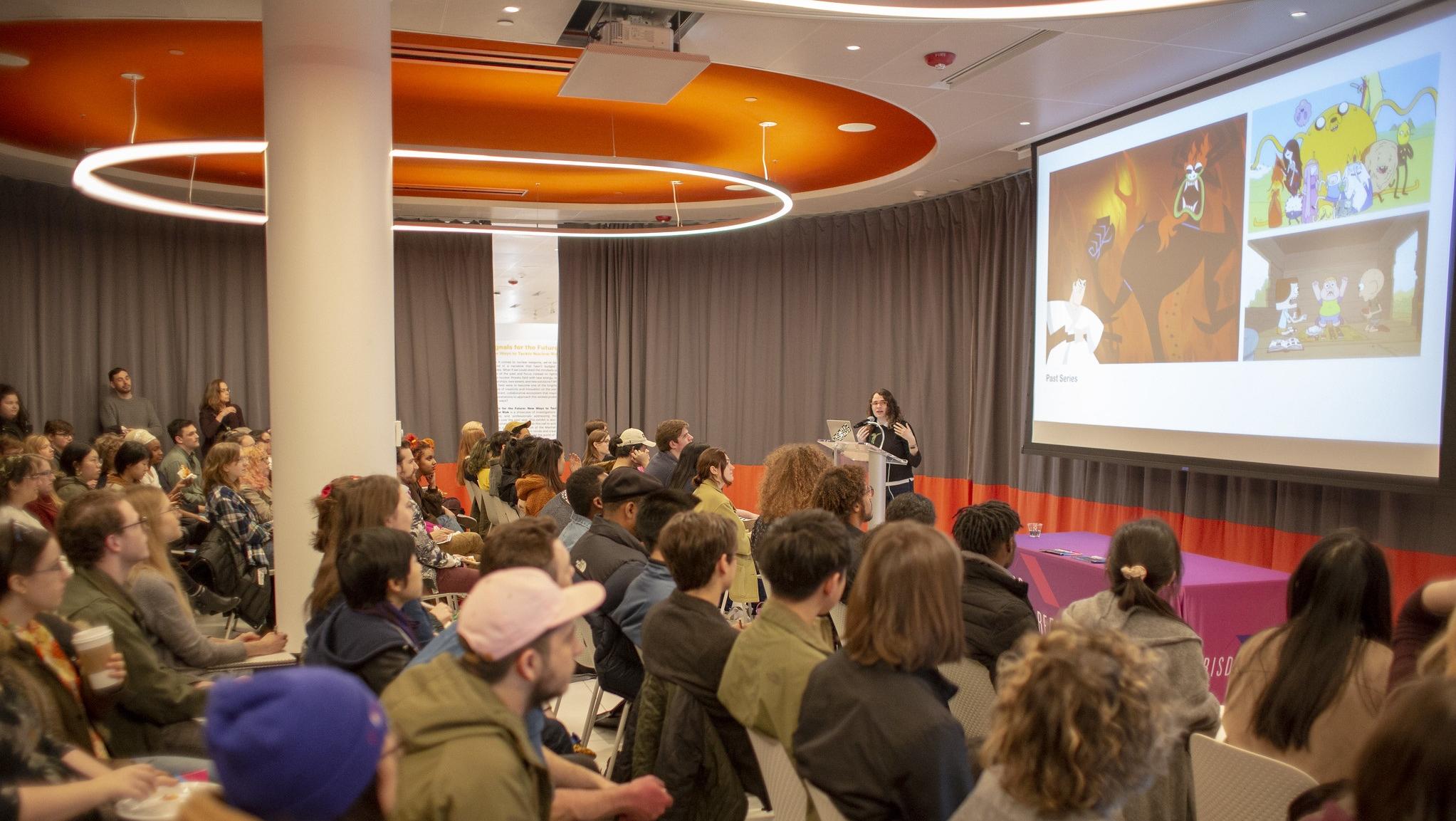 Recruiter speaking to students about their studio